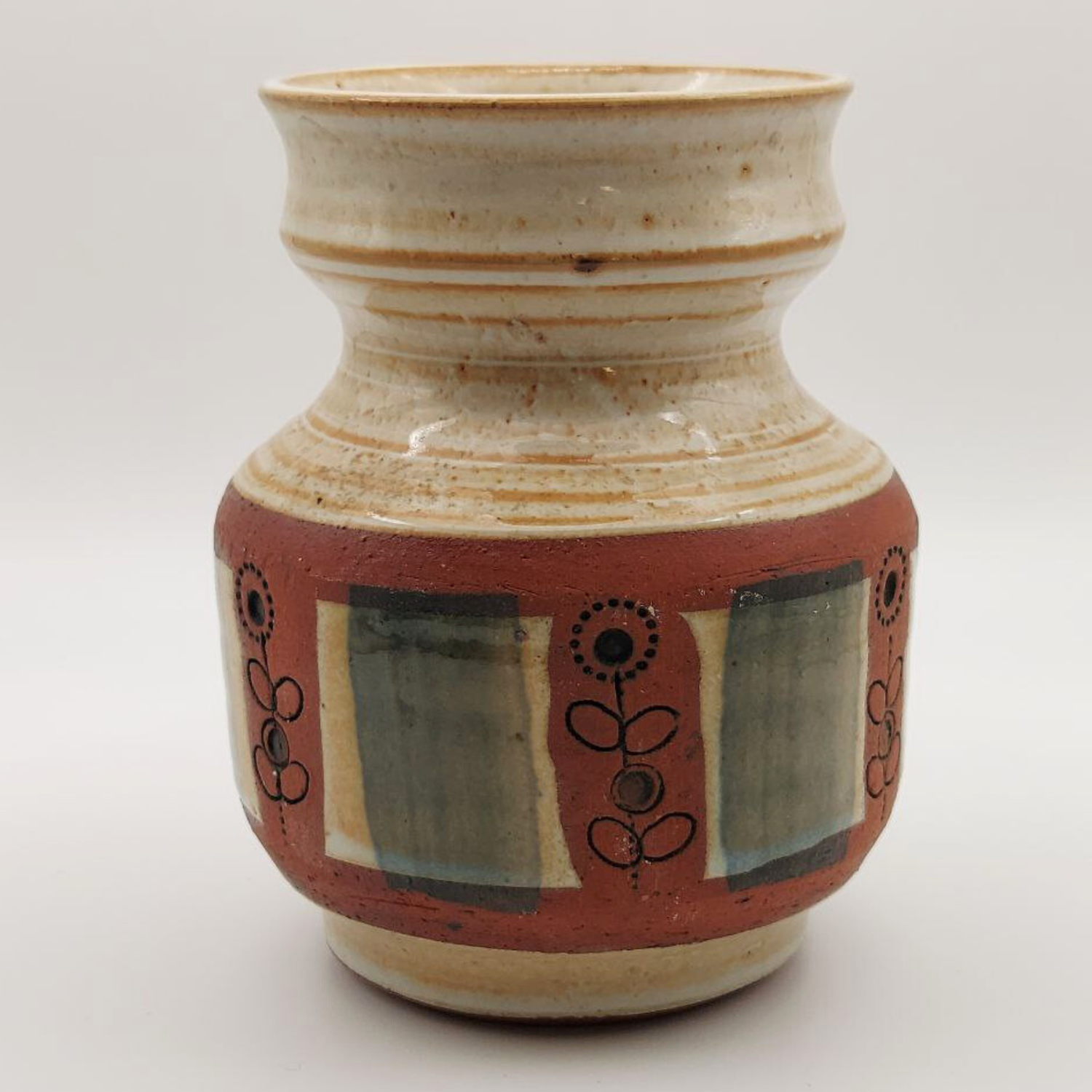 A pretty little vase with decorative patterns on a white background