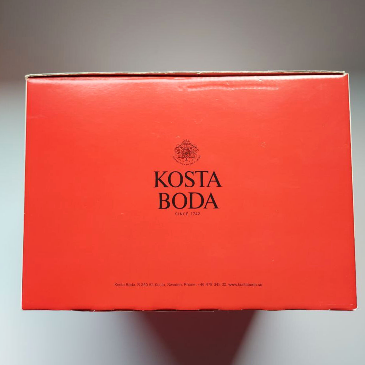 Red Kosta Boda box on a grey background