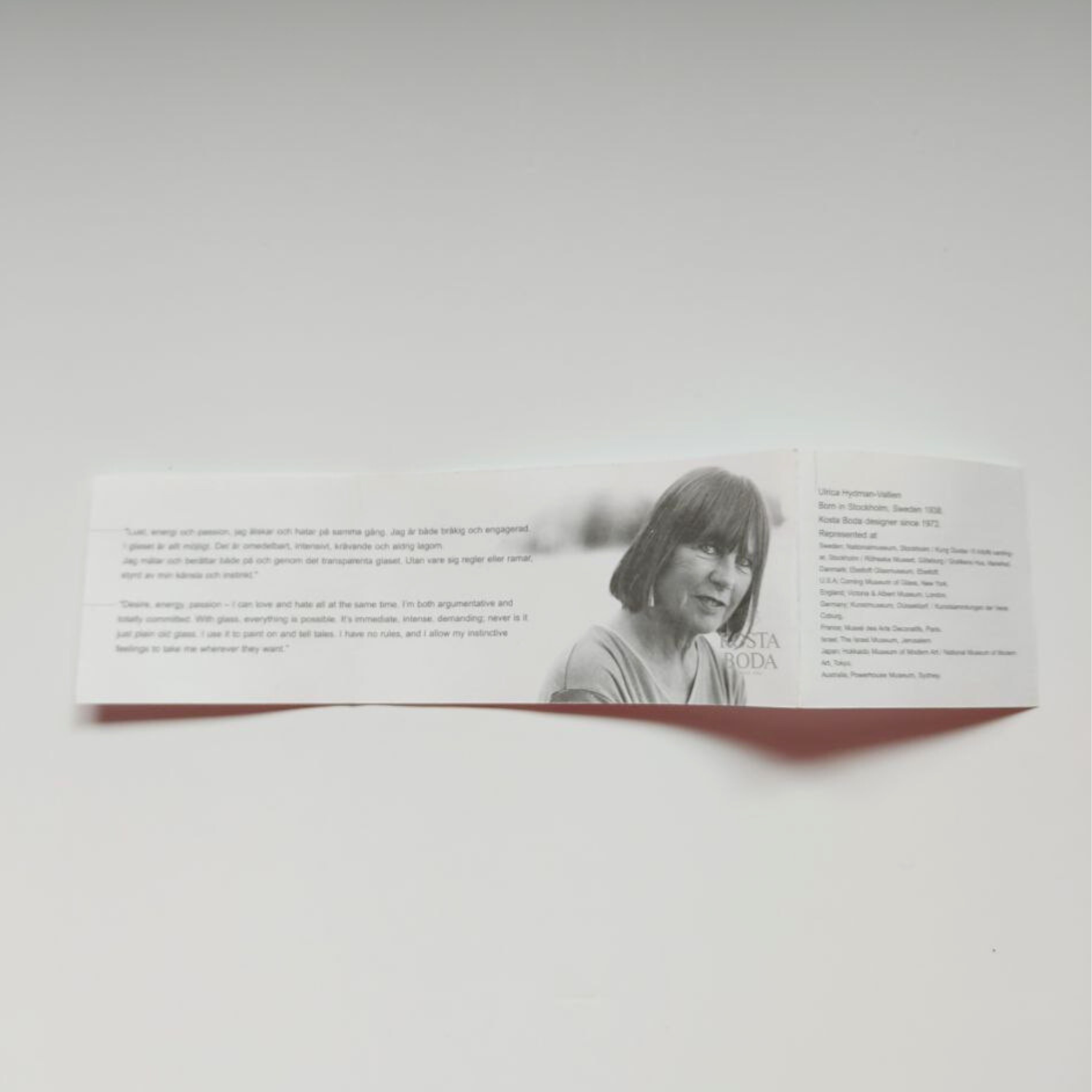 Folded paper with a photo of a person and text on a white background