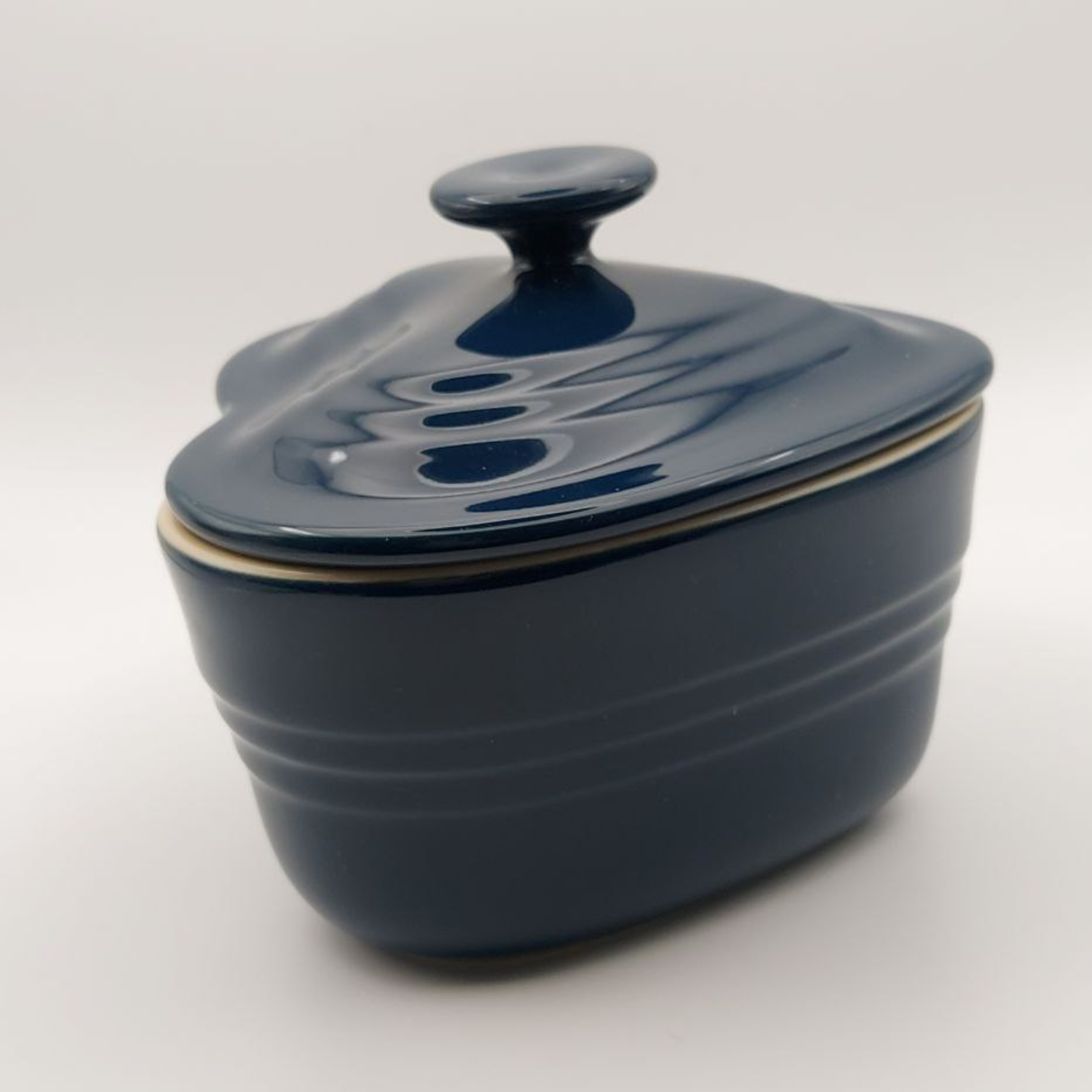 Blue ceramic lidded dish on a white background