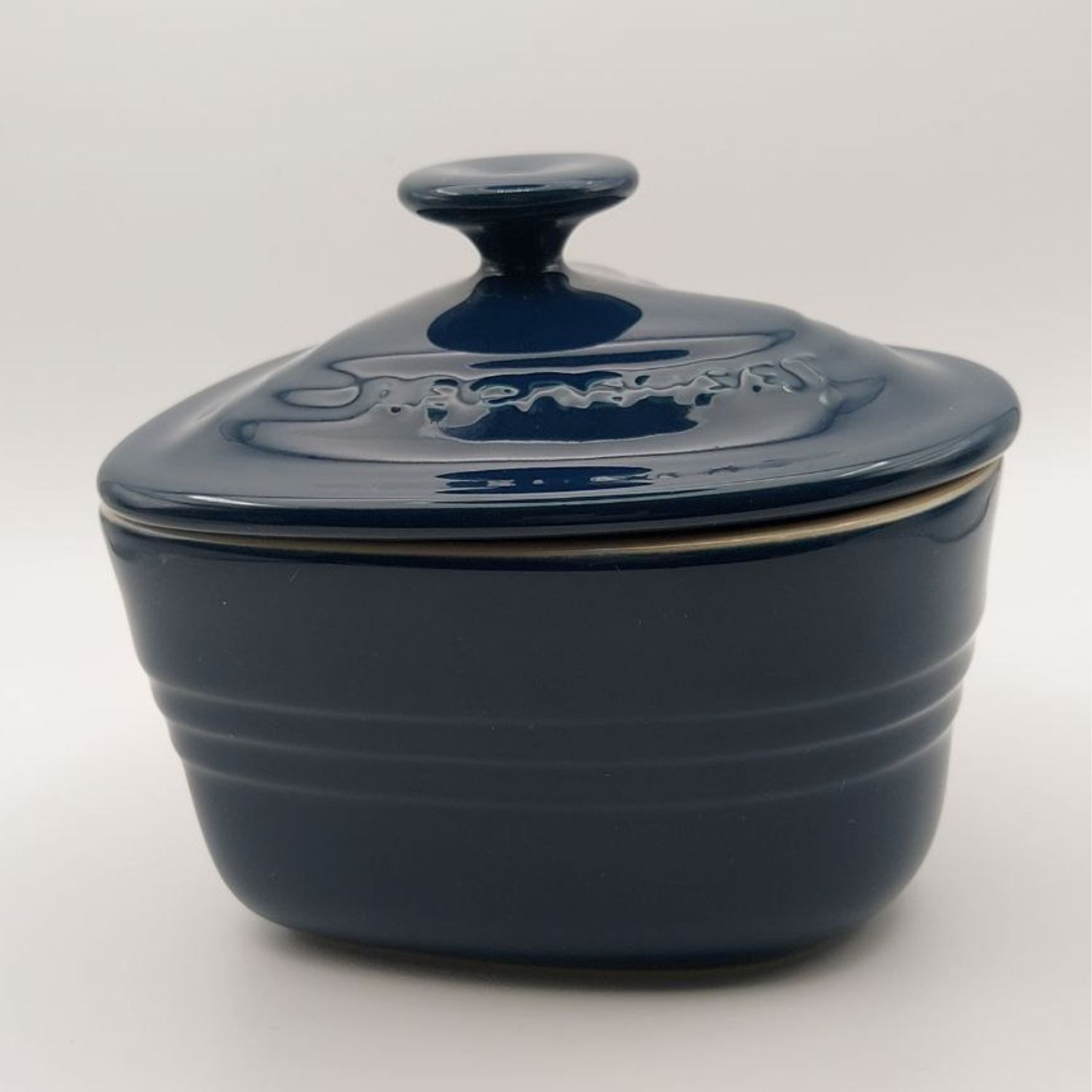 Blue ceramic dish with a lid on a white background