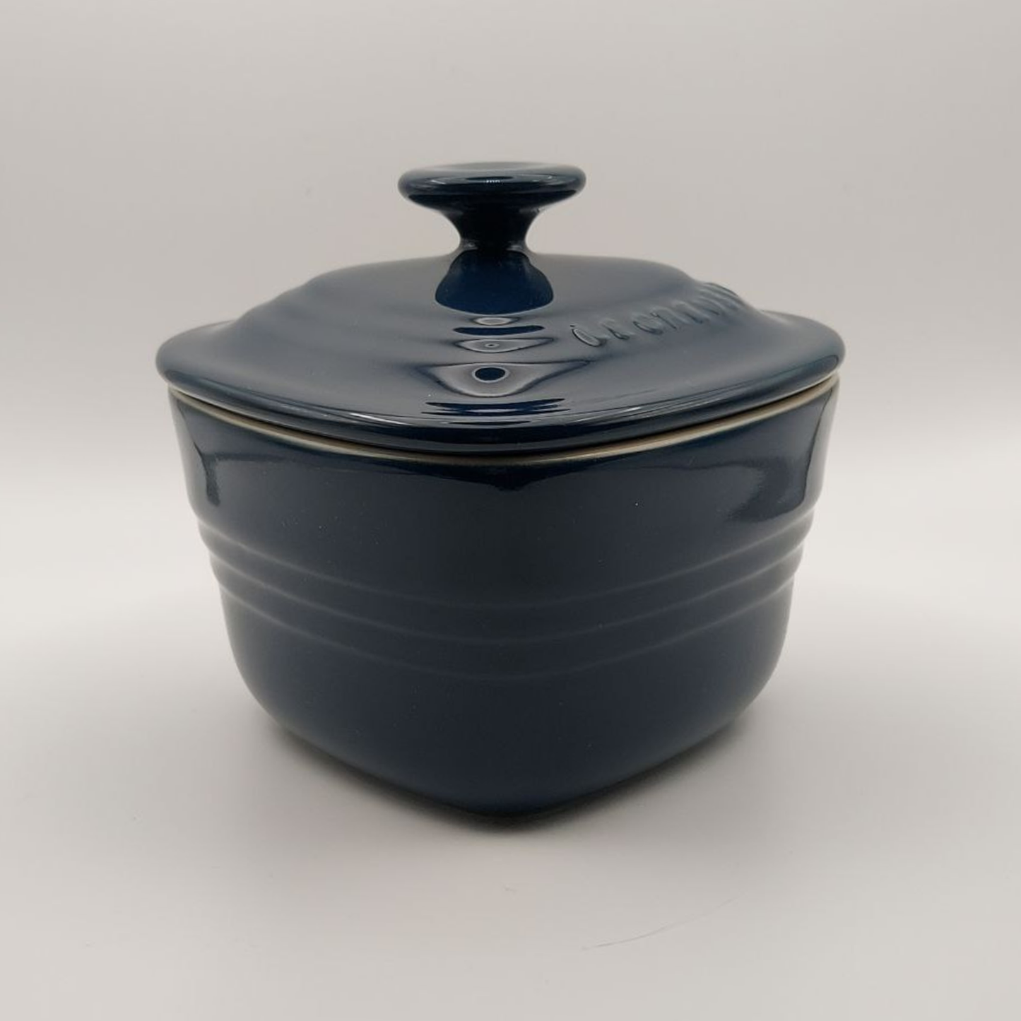 Blue ceramic pot with lid on a white background