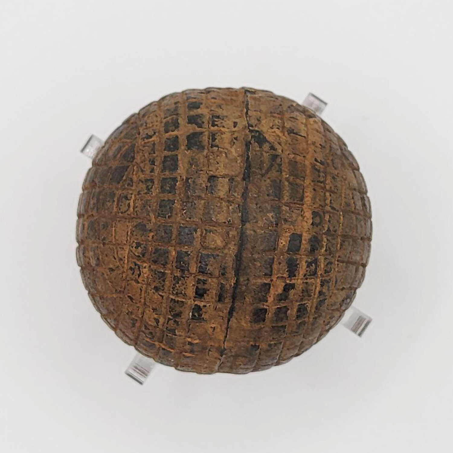 Textured brown golf ball on a white background
