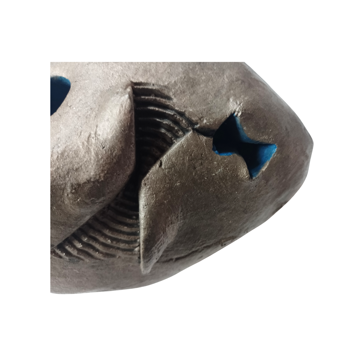 Close-up of an abstract sculpture with blue accents on a white background