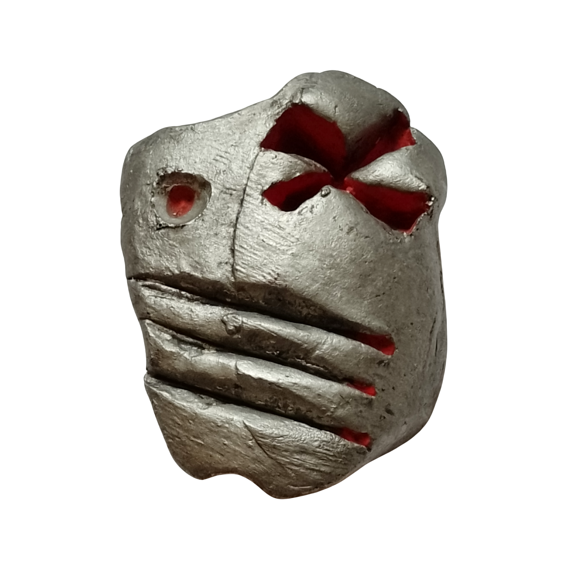Metallic sculpture figure with red eyes and mouth on a white background
