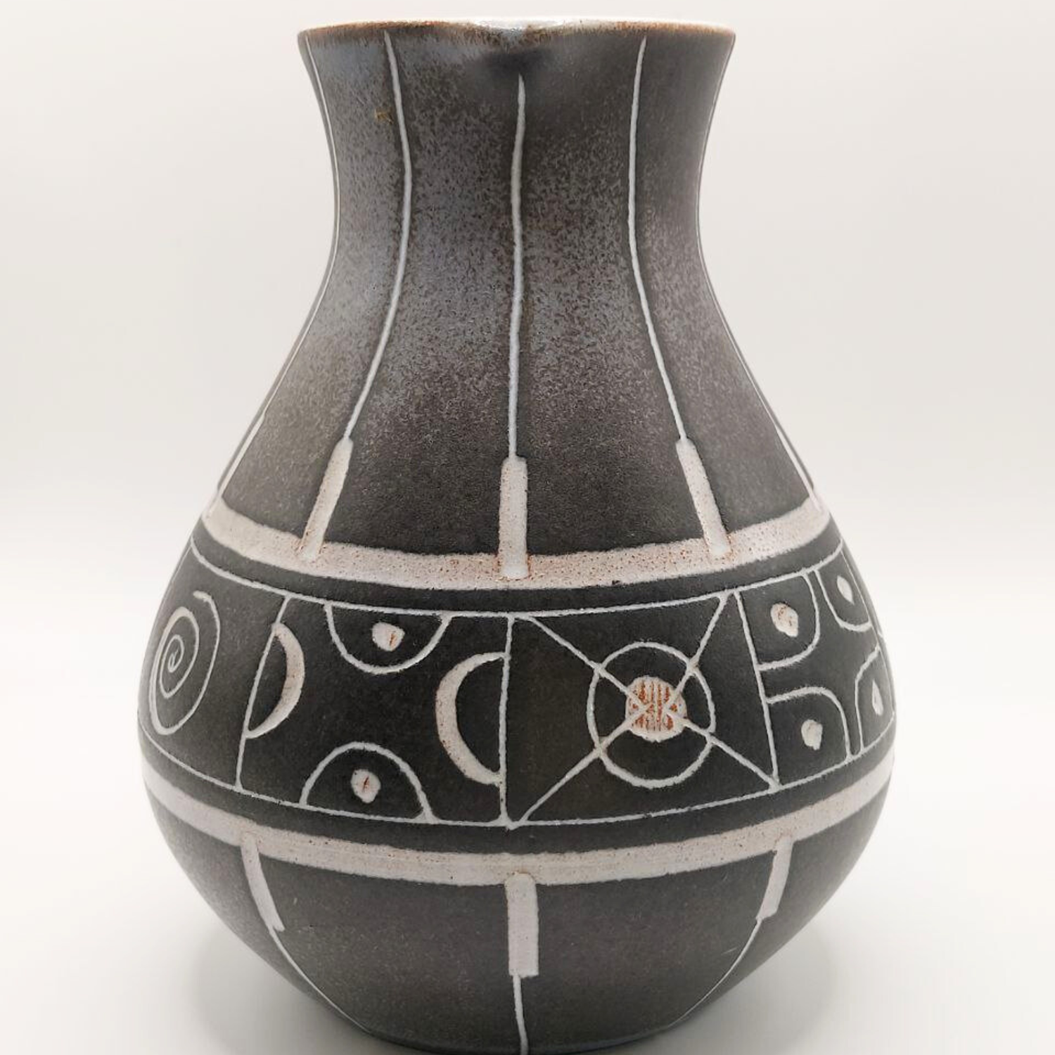 Grey ceramic vase with white geometric patterns on a white background