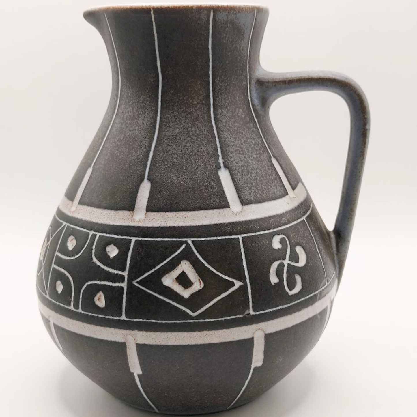 Grey Marschner jug / vase with geometric patterns on a white background