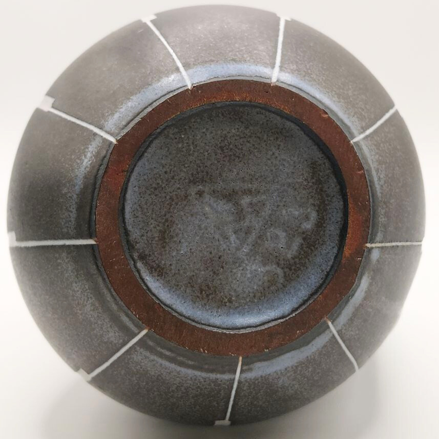 Round ceramic jug base with maker's mark and number on a white background