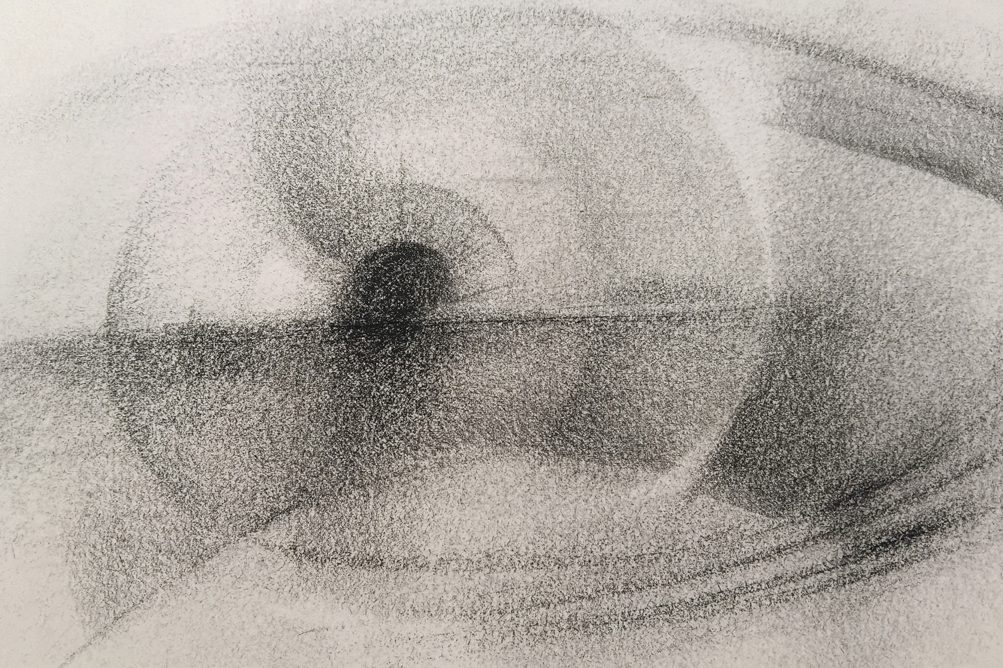 A monochrome charcoal sketch of an eye, showing textured shading and fine lines on a light background.