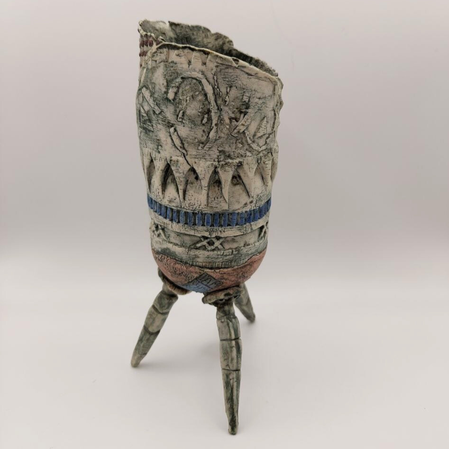 A Pam Schomberg vase against a grey backdrop