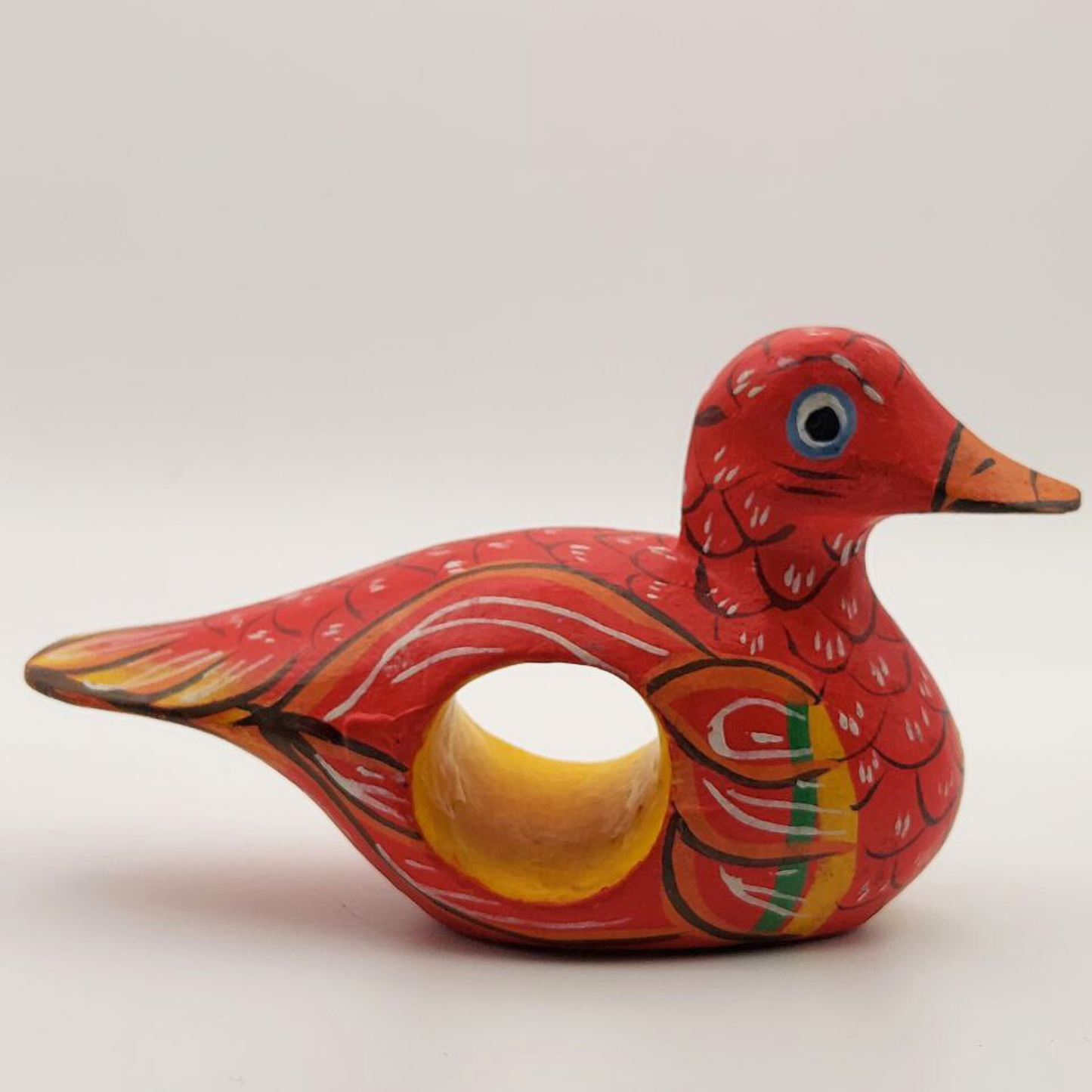 A red duck napkin holder on a white background