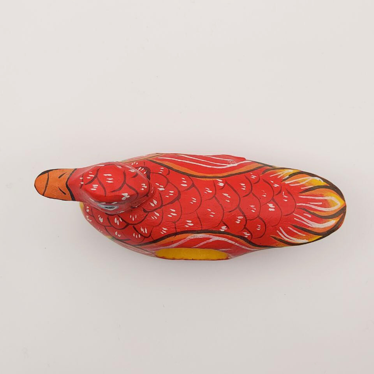 A top-down view of a red duck napkin holder