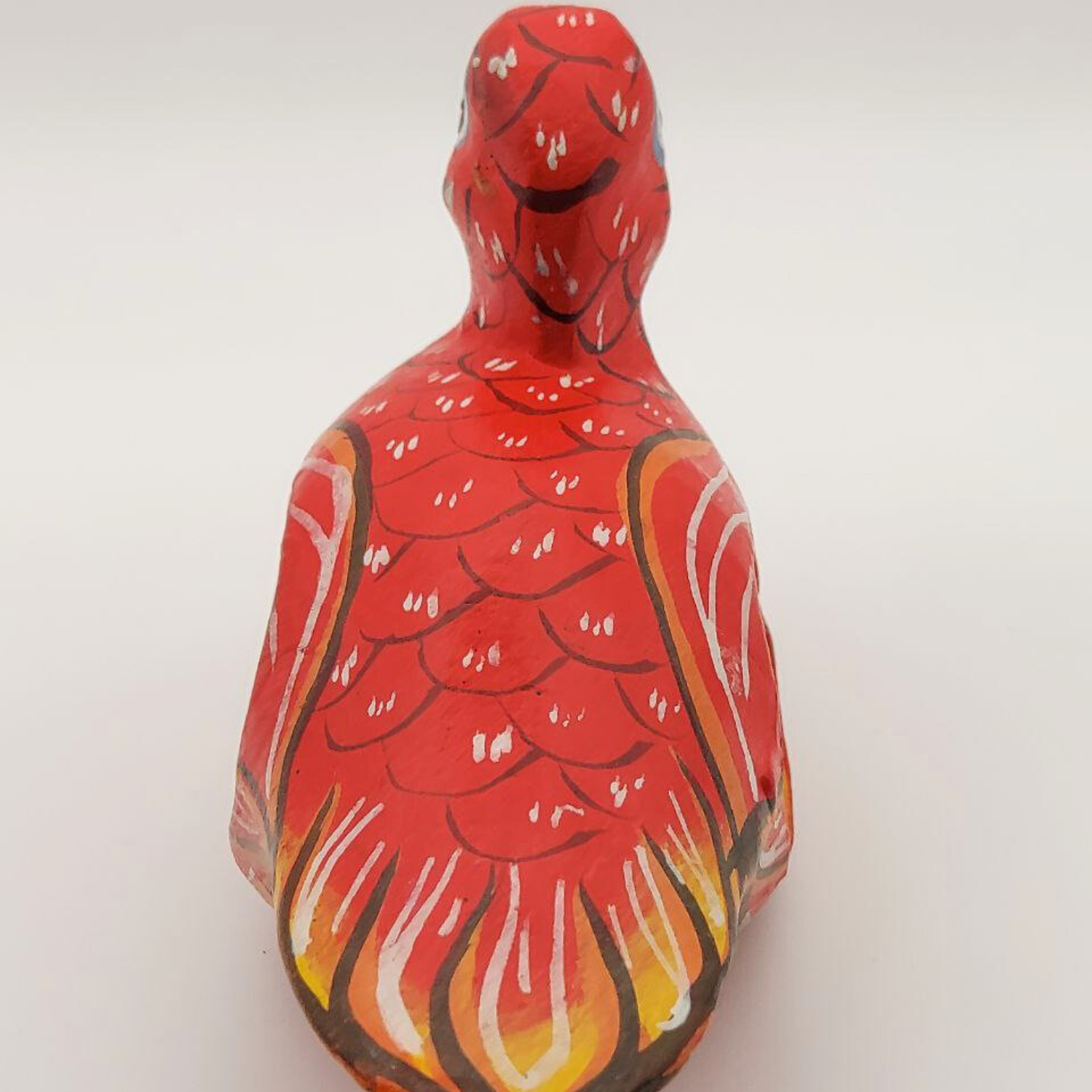 A red duck napkin holder taken from the back on a white background