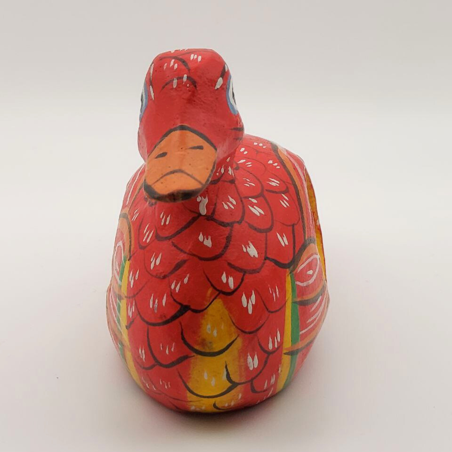 A face-on view of a red duck napkin holder on a white background