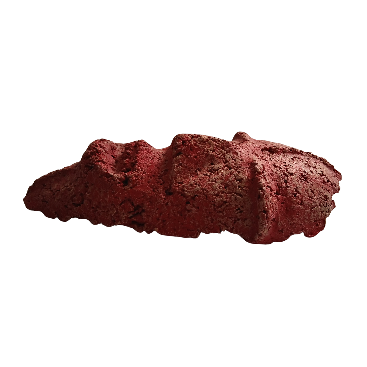A textured, porous red composite mask form the side, isolated on a solid white background.