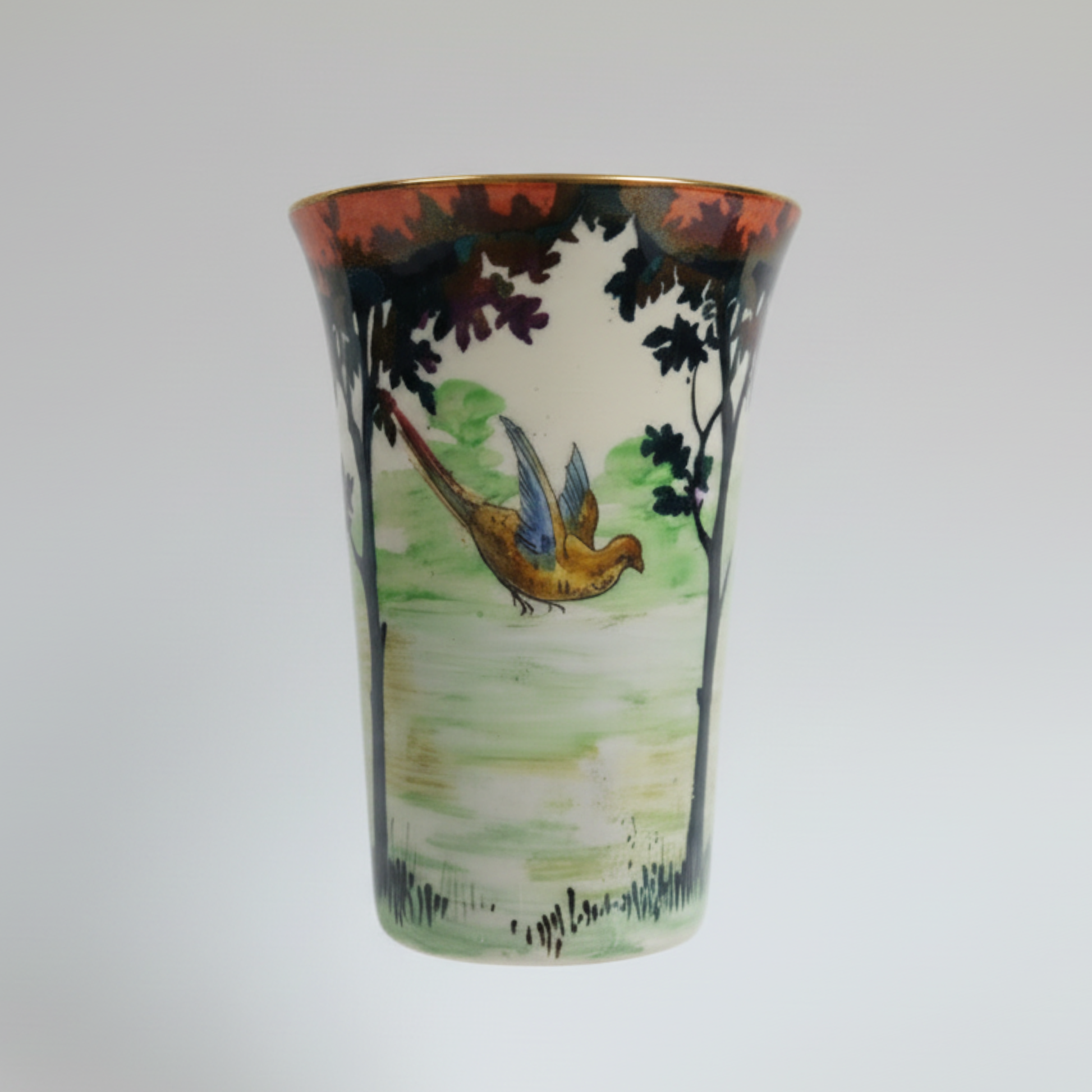 Decorative ceramic vase with nature-themed design on a white background