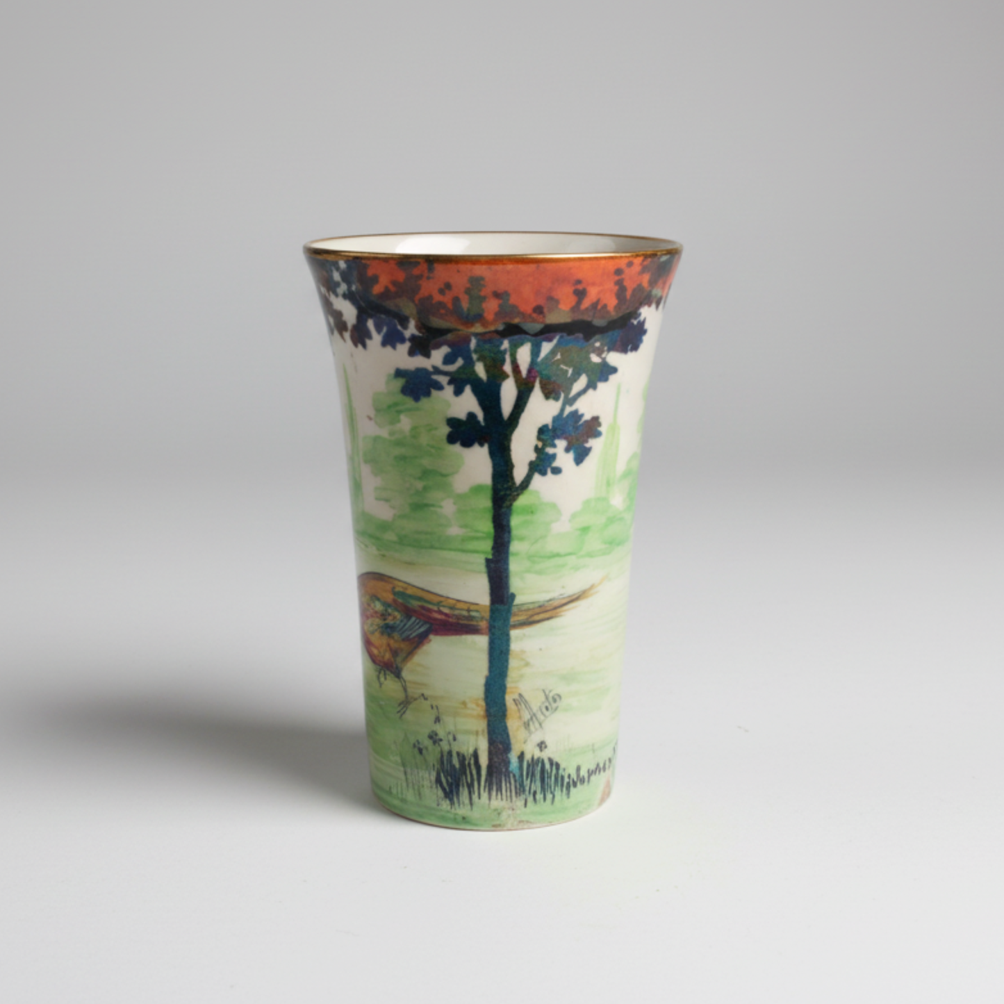 Vase with a scenic design of trees and a pheasant on a grey background