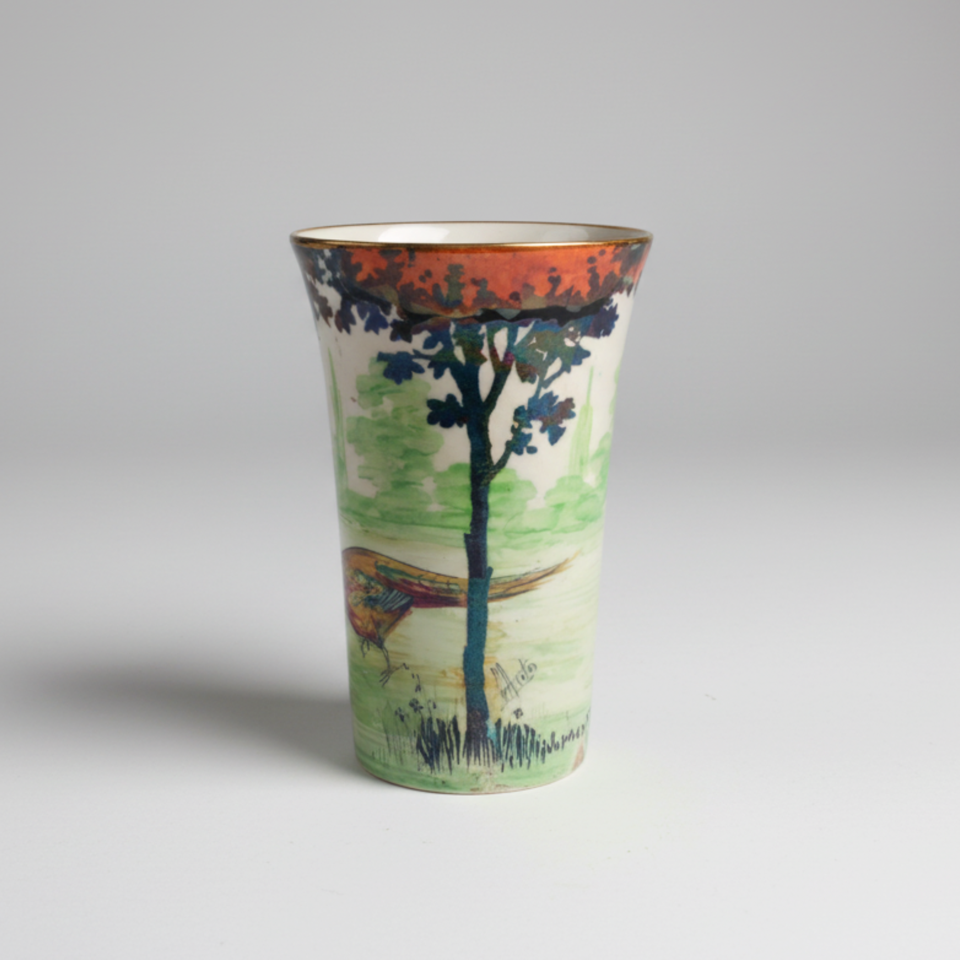 Vase with a scenic design of trees and a pheasant on a grey background