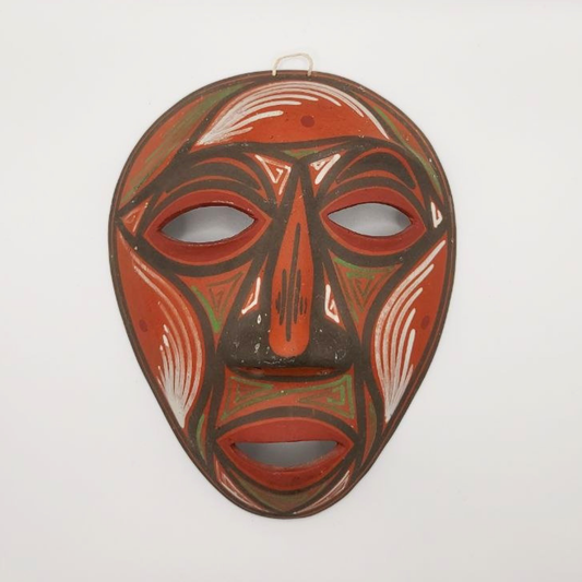 Traditional terracotta mask with red and brown colours on a white background