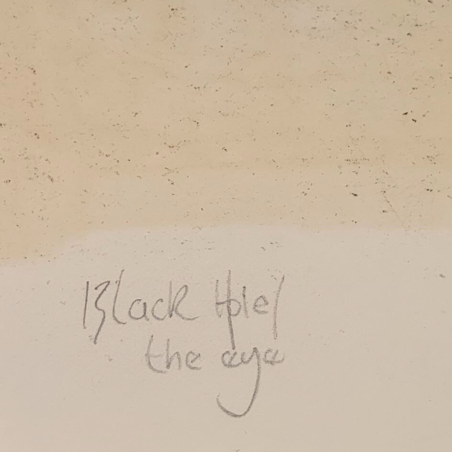 Text 'Black Hole/ the eye' on a textured beige background