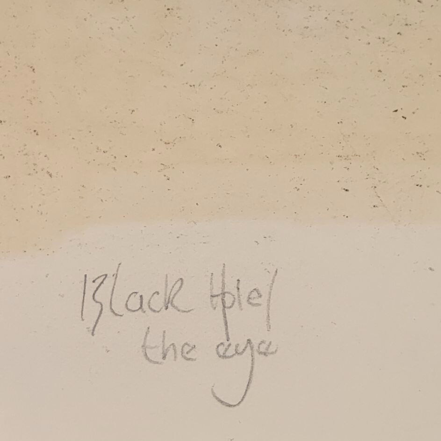 Text 'Black Hole/ the eye' on a textured beige background