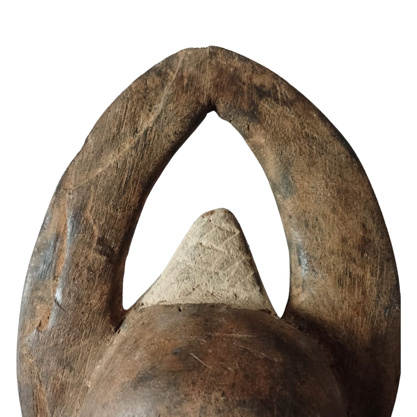 Close-up of a wooden mask with a pointed top on a white background