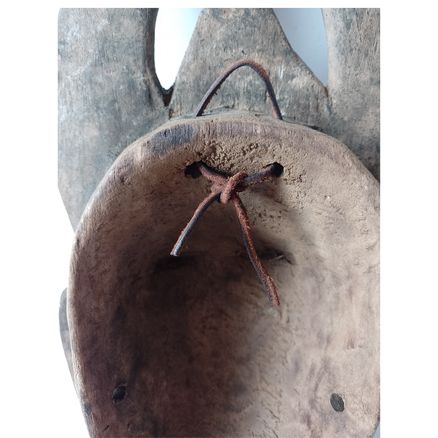 Close-up of the back of an African mask on a white background