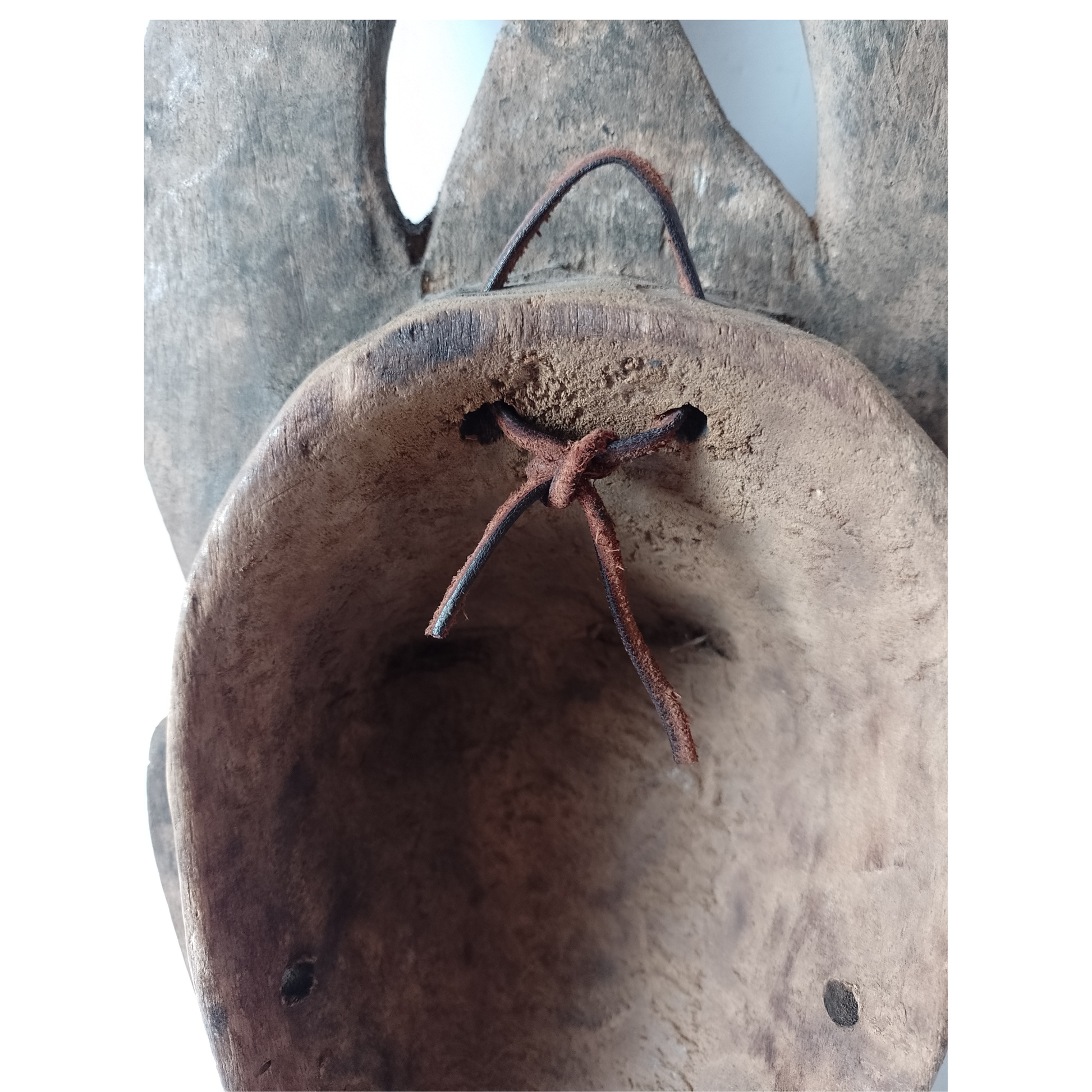 Close-up of the back of an African mask on a white background